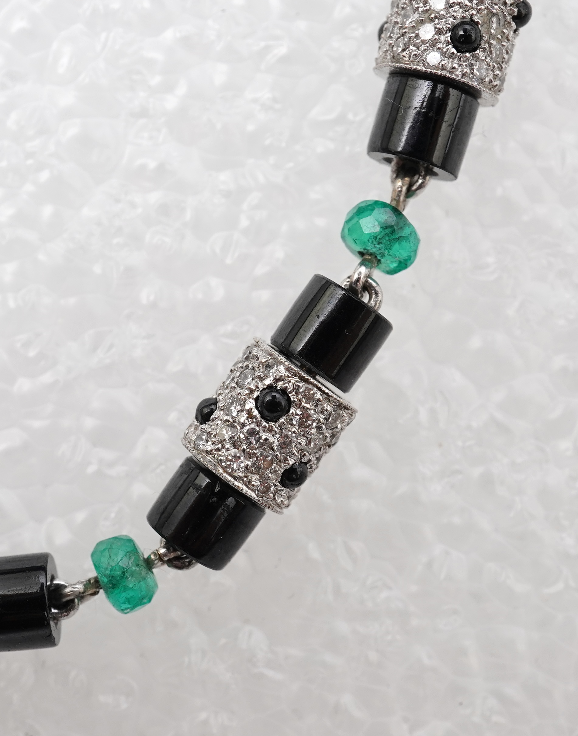 A stylish onyx, emerald and diamond bracelet